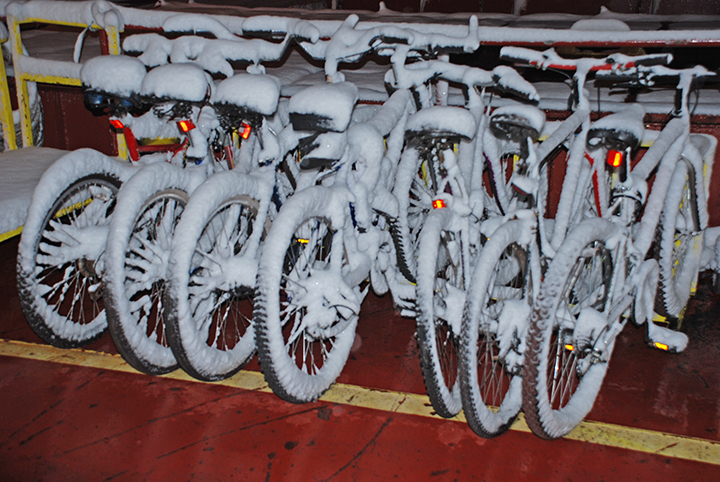 snow covered bikes on deck