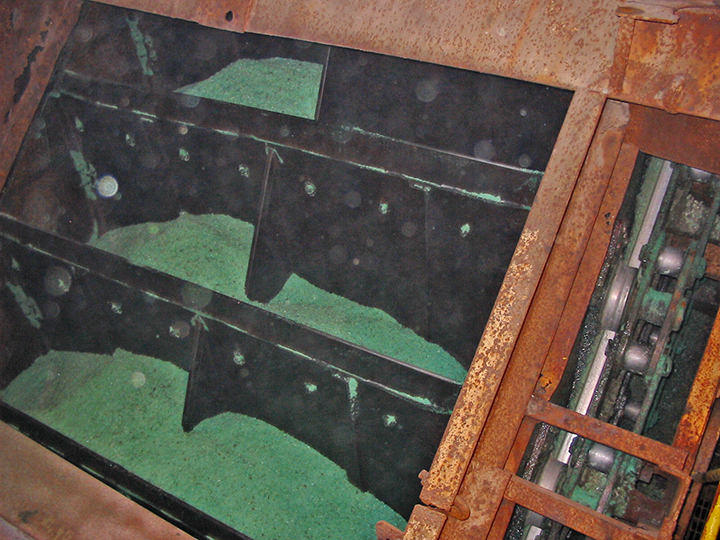 Elevator bucket unloading system