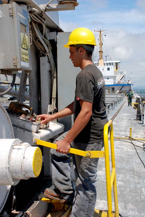 Deckhand operating hatch crane